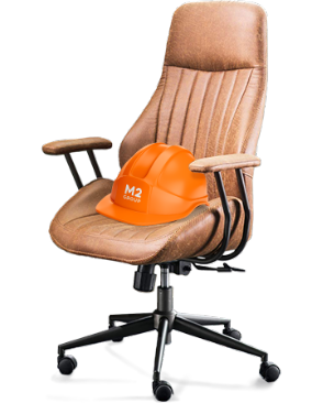 An M2 Group orange hardhat rests in an office chair