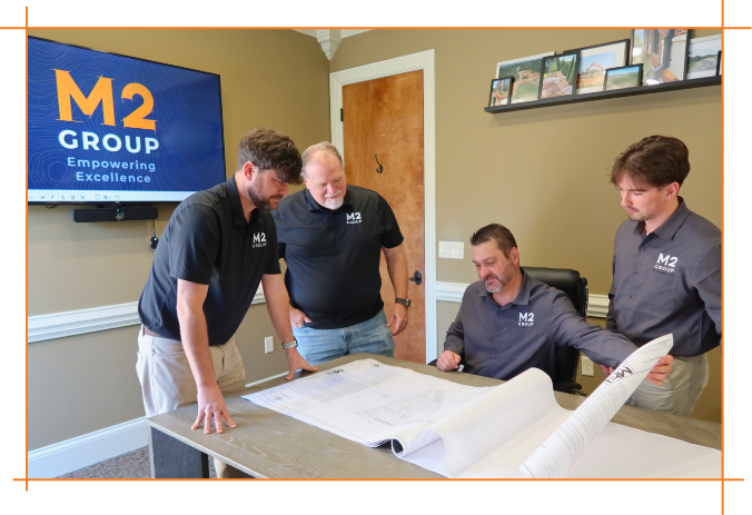 M2 Group looking over plans