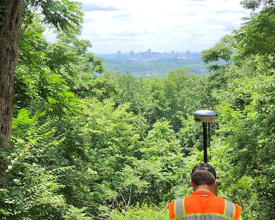 Land surveyor works with equipment in an open area