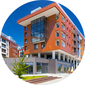 Modern mixed-use building with retail space on the ground floor and residential units above, designed for commercial and residential integration