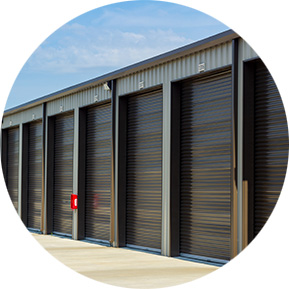 Modern storage facility with multiple roll-up doors, showcasing industrial storage and warehousing capabilities